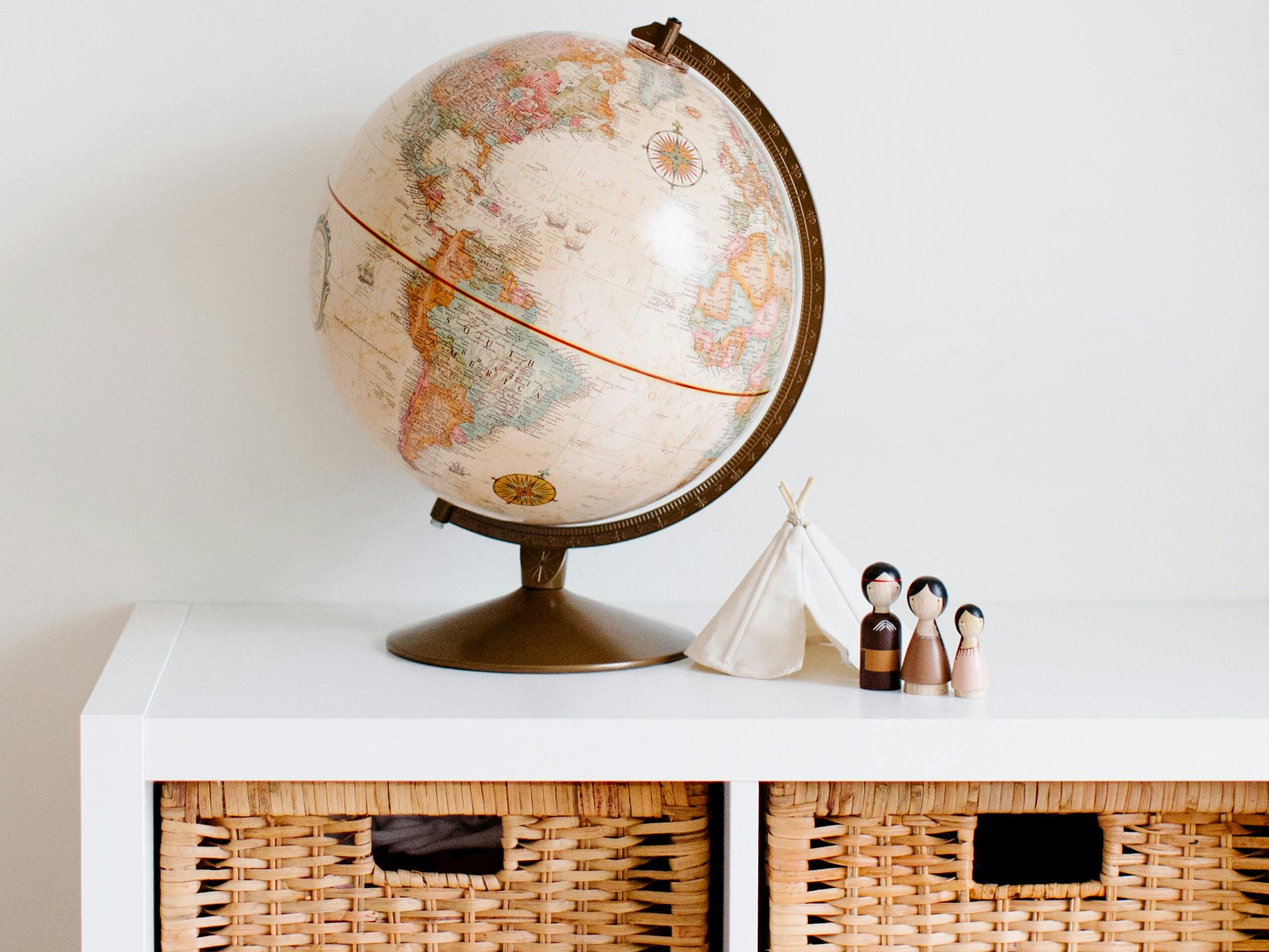 Cozy children's room with globe and toys, blending modern and vintage decor styles.